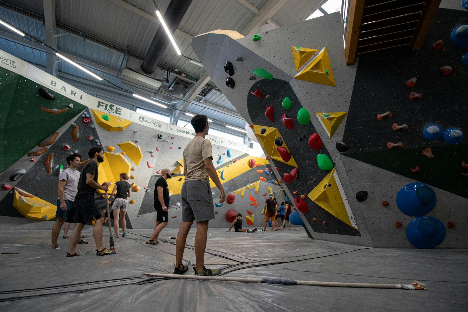 Guys at a climbing gym between climbs