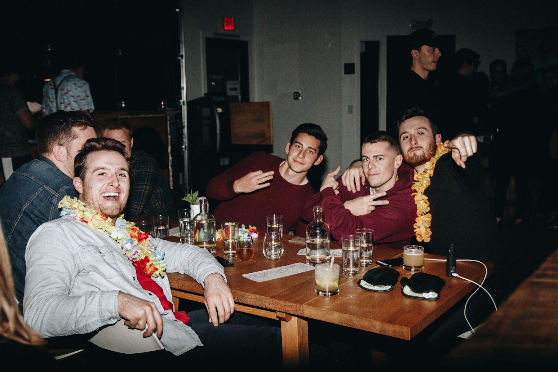 A group of guys hanging out around a table
